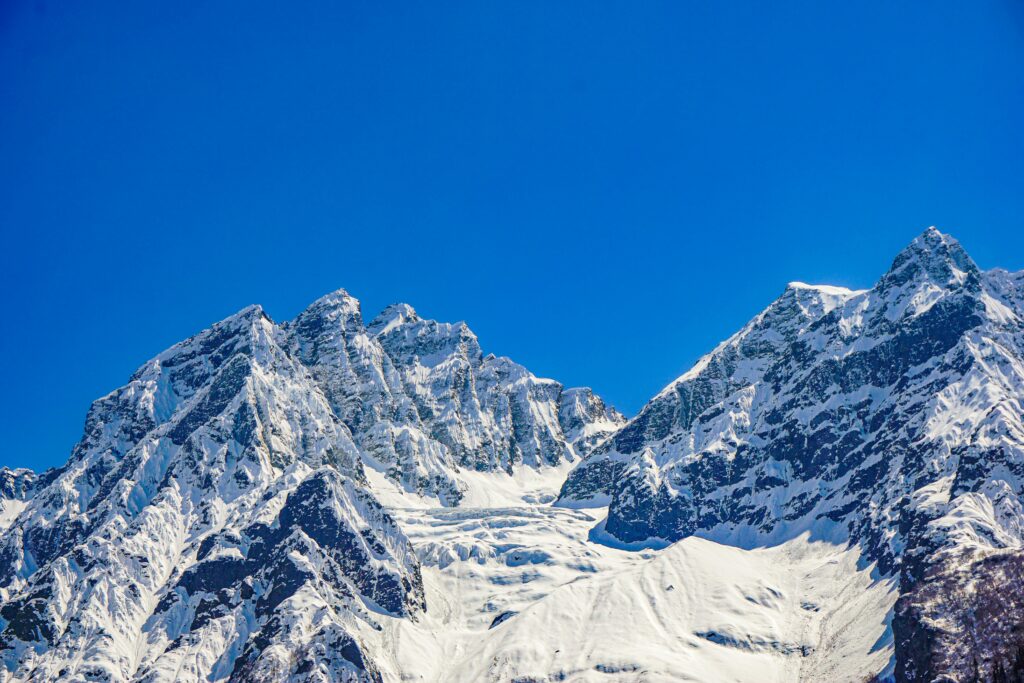 pexels-photo-19535685-19535685 Stunning view of the snow-covered mountains in Sonamarg under a clear blue sky.